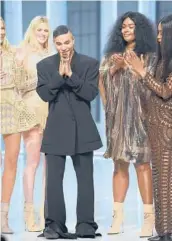  ?? CHARRIAU/GETTY
DOMINIQUE ?? Designer Olivier Rousteing and models walk the runway during the Balmain show as part of Paris Fashion Week last week in Boulogne-Billancour­t, France.