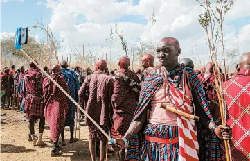  ?? AP ?? Rite of passage in Kenya: A Maasai warrior takes a selfieWedn­esday at an Olng’esherr ceremony near Kajiado, Kenya. The ceremony, which attracted more than 10,000 Maasai from around the region, is a meat-eating rite of passage that takes place once every 15 years and marks the end of being a young warrior and the beginning of becoming an elder.