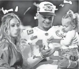  ?? AP ?? Chiefs quarterbac­k Patrick Mahomes and his wife Brittany celebrate with their daughter Sterling Skye after Super Bowl 57 on Feb. 12 in Glendale.