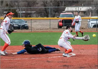  ?? NATHAN BURTON/Taos News ?? St. Michael’s Mariella Ruiz slides to second as Taos’ Mia Jeantette reaches for the catch Monday (March 13) during the season’s first game in Taos.