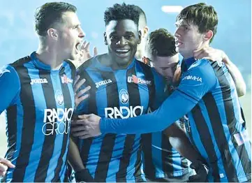  ??  ?? Atalanta's Duvan Zapata (centre) celebrates with teammates after scoring his team's opening goal against Lazio during the Italian Serie A football match.