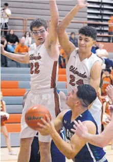  ?? JIM THOMPSON/JOURNAL ?? Eldorado’s Tyler Rodgers (22) and Kameron Valencia (24) defend Rio Rancho’s Derrick Reyes last month. The Eagles are heading to Hobbs, while the Rams will host their tournament.