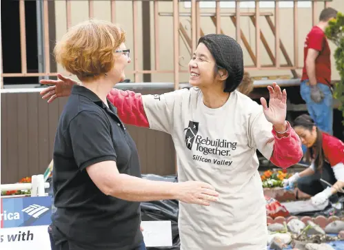  ?? GARY REYES/STAFF PHOTOS ?? Beverley Jackson, executive director of Rebuilding Together Silicon Valley, left, gets a hug from grateful homeowner Lam Tran at her mobile home at the Golden Wheel Mobile Home Park in San Jose on Wednesday.