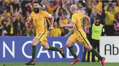  ?? AFP ?? Australia’s Mile Jedinak (left) celebrates after scoring in their 2018 World Cup qualificat­ion play-off match against Honduras at Stadium Australia in Sydney yesterday. Australia won 3-1.