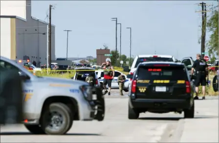  ?? TIM FISCHER — MIDLAND REPORTER-TELEGRAM VIA AP ?? Odessa and Midland police and sheriff’s deputies surround the area behind Cinergy in Odessa, Texas, Saturday after reports of shootings. Police said there are “multiple gunshot victims” in West Texas after reports of gunfire on Saturday in the area of Midland and Odessa.