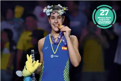  ?? AFP ?? Carolina Marin of Spain poses with her medal on the podium after defeating PV Sindhu of India in the women’s singles final of the badminton World Championsh­ips on Sunday. —