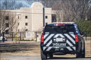  ?? Brandon Bell / Getty Images ?? A law enforcemen­t vehicle sits near the Congregati­on Beth Israel synagogue Sunday in Colleyvill­e, Texas. All four people who were held hostage at the synagogue were safely released after more than 10 hours of being held captive by a gunman. Police had responded Saturday after reports of a hostage situation.