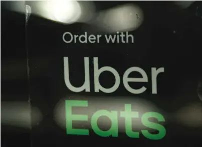  ?? AP ?? Uber Eats, Grubhub, DoorDash and other third-party online order and delivery services charge restaurant­s for their services, but those fees would be capped under a new Chicago ordinance.