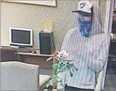  ?? SUBMITTED PHOTO ?? The man shown in this screen shot of surveillan­ce footage released by the RCMP is suspected in the robberies of three locations in Prince Edward Island.