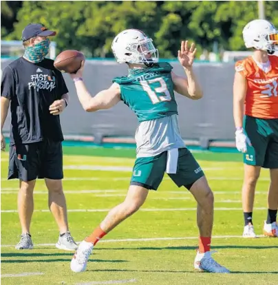  ?? TIM BROGDON/MIAMI ATHLETICS ?? Miami quarterbac­k Jake Garcia throws a pass during his first spring practice as a freshman early enrollee.