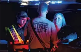  ?? MARK WALLHEISER/GETTY ?? Emergency personnel work outside the Hot Yoga studio in Tallahasse­e after a gunman shot six people, killing two of them.