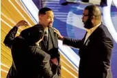  ?? ?? Sean Combs (left) and Tyler Perry (right) talk to Smith after Smith’s altercatio­n with Rock at the Dolby Theatre in Los Angeles.