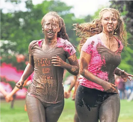  ?? Pictures: Mhairi Edwards and Paul Reid. ?? Caitlin Mitchell, 18 from Menzieshil­l and Lois Winter, 17 from Fife coming up to the finish of the Race for Life in Camperdown Park.