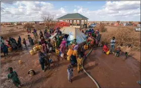  ?? ?? Water is distribute­d Sept. 20 at a camp for displaced people on the outskirts of Dollow.