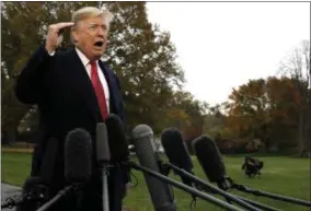  ?? EVAN VUCCI — THE ASSOCIATED PRESS ?? President Donald Trump talks to the media Friday before boarding Marine One on the South Lawn of the White House in Washington.