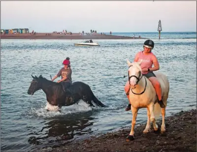  ??  ?? Riders take their horses into the sea July 22 in Shaldon.
