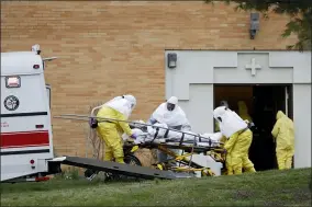  ?? SETH WENIG — THE ASSOCIATED PRESS ?? A residents from St. Joseph’s Senior Home is loaded into a bus in Woodbridge, N.J., Wednesday, March 25. More than 90resident­s of the nursing home in Woodbridge are being transferre­d to a facility in Whippany after 24 tested positive for COVID-19, according to a spokeswoma­n for CareOne, which operates the Whippany facility. The facility has moved its residents to other facilities to accommodat­e the new arrivals.