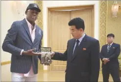  ?? The Associated Press ?? Former NBA basketball star Dennis Rodman presents a book titled “Trump The Art of the Deal” to North Korea’s Sports Minister Kim Il Guk on Thursday in Pyongyang, North Korea.