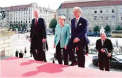  ?? — AFP ?? BERLIN: German Chancellor Angela Merkel and the President of the Federation of German Industry (BDI) Dieter Kempf (R) arrive for a two-day meeting of the Federation of German Industry (BDI).