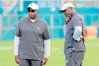  ?? AMY BETH BENNETT/SUN SENTINEL ?? Dolphins general manager Chris Grier, left, and coach Brian Flores are hoping some of the former first-round draft picks they’ve acquired can resurrect their careers in Miami.