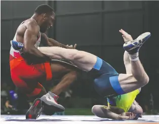  ?? SCOTT BARBOUR/GETTY IMAGES FILES ?? Amateur wrestler Jevon Balfour, left, hopes to qualify for the Tokyo Olympics, but he was told by the sport’s internatio­nal governing body that he is no longer eligible to compete.