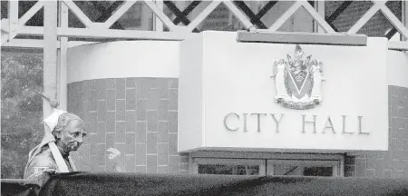  ??  ?? A statue of John A. MacDonald outside Victoria’s City Hall is brought down.