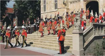  ??  ?? Yeomen of the Queen’s Body Guard parade down the steps from the west entrance of St George’s chapel, Windsor Castle, where Prince Harry and Meghan Markle will marry next month