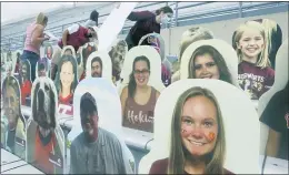  ?? MATT GENTRY — THE ROANOKE TIMES VIA AP ?? Athletic Department members, ticket office workers and Hokie Club personnel attach over 1,000 fan cutouts to seats of Lane Stadium in preparatio­n for Saturday’s Virginia Tech against North Carolina State game in Blacksburg, Va..