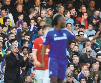  ?? Ben Stansall / AFP / Getty Images ?? Coach Jose Mourinho, clapping at left during Chelsea’s 1- 0 victory over Manchester United on Sunday, succeeds by knowing his players well and building a belief in their ability to win.