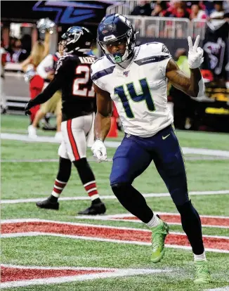  ?? PHOTOS BY CURTIS COMPTON / CCOMPTON@AJC.COM ?? Seattle’s DK Metcalf cruises into the end zone after a “miscommuni­cation” between two defensive players for the Falcons during last week’s 27-20 loss at home.