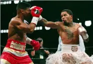  ?? TAMI CHAPPELL - THE ASSOCIATED PRESS ?? Gervonta Davis, right, lands a punch on Yuriorkis Gamboa during round eight for the WBA lightweigh­t boxing bout Sunday, Dec. 29, 2019, in Atlanta. Davis won the title by a 12th round TKO.