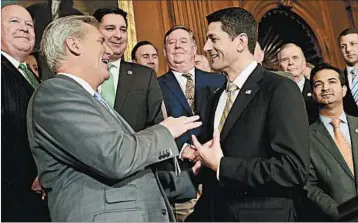  ?? CHIP SOMODEVILL­A/GETTY ?? House Majority Leader Kevin McCarthy, left, and Speaker Paul Ryan celebrate House passage of tax reform this month.