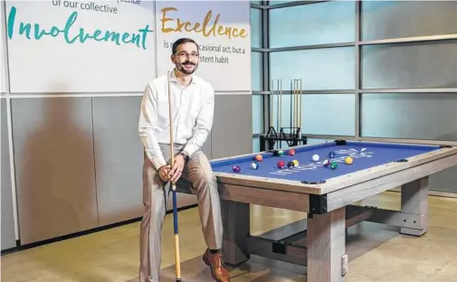  ?? Marie D. De Jesús / Staff photograph­er ?? After the Houston office of Improving beat $7 million in revenues last September, President Devlin Liles says the office got a pool table. This year, the team is working toward $20 million in revenues to upgrade its beer dispenser.