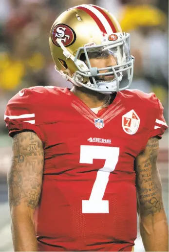  ?? Stephen Lam / Special to The Chronicle ?? 49ers quarterbac­k Colin Kaepernick, seen in his first preseason action Friday against Green Bay, explained why he sat during the national anthem before the game and will continue to do so.