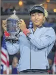  ?? Chris trotman / Getty images ?? naomi osaka poses with the championsh­ip trophy after winning her first major title at the u.s. open.