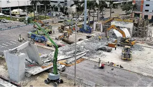  ?? PEDRO PORTAL/MIAMI HERALD VIA AP ?? Recovery operations continue Saturday at the site of the Florida Internatio­nal University-Sweetwater bridge in the Miami area that collapsed during constructi­on last week. Authoritie­s say at least six people were killed.