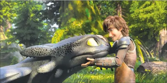  ?? Universal Pictures ?? THE NIGHT FURY dragon Toothless cuddles up to the young Viking leader Hiccup (voiced by Jay Baruchel) in “How to Train Your Dragon: The Hidden World.”