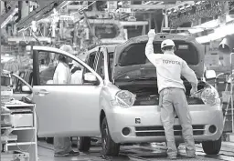  ?? TOKYO
-AP ?? Workers seen in Toyota assembly line in Japanese capital.