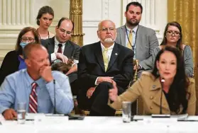  ?? Chip Somodevill­a / Getty Images ?? CDC Director Robert Redfield, center, has no seat at the table during a Tuesday event to discuss reopening schools with students, teachers and administra­tors with President Donald Trump at the White House.