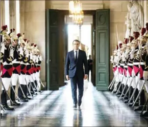  ?? AFP/POOL/ETIENNE LAURENT ?? French President Emmanuel Macron walks through the Galerie des Bustes to access the Versailles Palace for a special congress gathering both houses of parliament, outside Paris, on Monday.