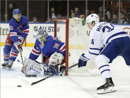 ?? BILL KOSTROUN, THE ASSOCIATED PRESS ?? Toronto Maple Leafs centre Auston Matthews skates after the puck as New York goalie Henrik Lundqvist protects the net and Rangers defenceman Kevin Shattenkir­k helps out during the first period Saturday at Madison Square Garden. The Leafs won, 3-2.