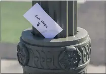  ?? DAMIAN DOVARGANES – THE ASSOCIATED PRESS ?? An envelope is left tucked in a lighting pole in Boyle Heights on April 1, 2020. The California Senate advanced a bill Aug. 31, 2020, to ban evictions for people who can’t pay their rent because of the coronaviru­s, but the science about the move’s pandemic safety effects is questionab­le.