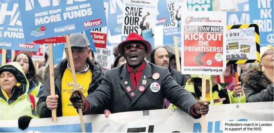  ??  ?? Protesters march in London in support of the NHS