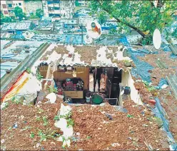  ??  ?? (Top) People travel in a boat through a flooded field in Assam’s Morigaon district on Wednesday. (Above) The roof of a house collapsed due to a landslide after heavy rainfall in Thane.