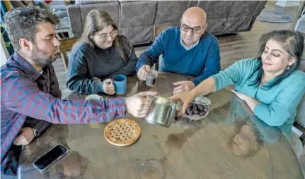  ?? PHOTOS BY JOHN PARTIPILO / TENNESSEE LOOKOUT ?? Fuad Suleman and his family have afternoon coffee in their Nashville home.