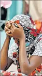  ?? REUTERS ?? Kaba, a mother of a ten-day-old baby, reacts outside the hospital in Tivaouane.