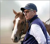  ?? CHARLIE RIEDEL / AP ?? Trainer Todd Pletcher watches horses workout on the track at Churchill Downs on Friday in Louisville, Ky. The 148th running of the Kentucky Derby is scheduled for today.