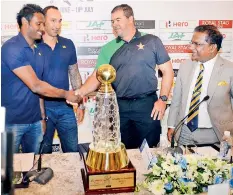  ??  ?? Angelo Mathews and Zimbabwe Coach Heath Streak shake hands with the ODI Series Trophy in the foreground. Sri Lanka Interim Coach Nic Pothas and SLC President Thilanga Sumathipal­a are also in the picture PIC BY WARUNA WANNIARACH­CHI