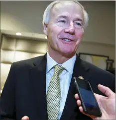  ??  ?? In this Saturday photo, Arkansas Gov. Asa Hutchinson speaks with a reporter in Washington. On Monday Hutchinson scheduled execution dates for eight inmates in an attempt to resume the death penalty after a nearly 12-year hiatus, even though the state...