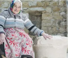  ?? (Beit Zinati) ?? MARGALIT ZINATI poses with an ancient stone discovered in her home village of Peki’in near the Western Galilee.